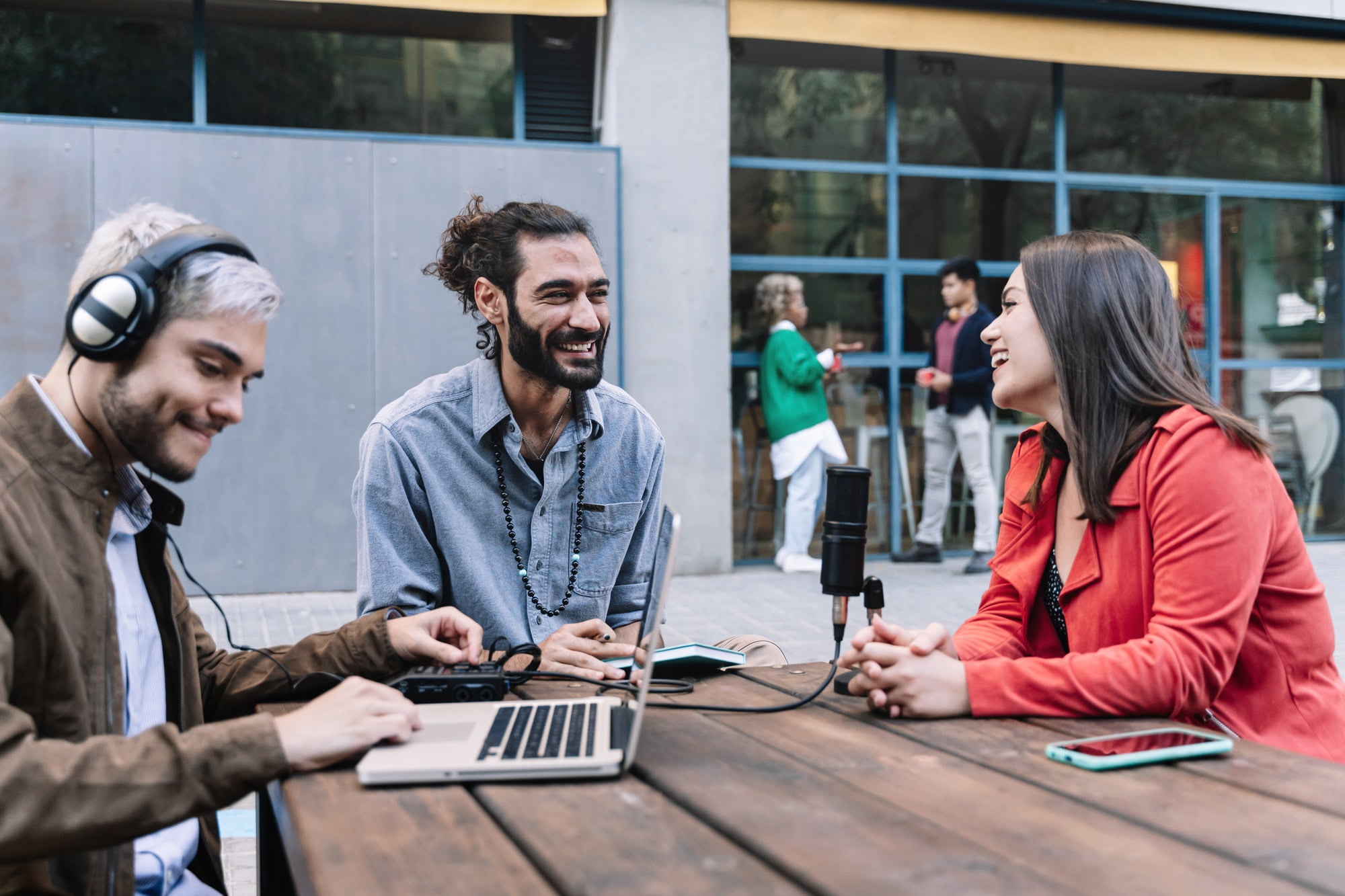 Young content creator journalist recording informal interview conversation with modern woman